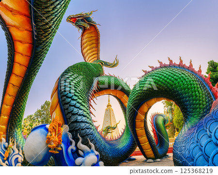Rainbow carve serpent surrounded Sri Maha Pho Chedi stupa in at Wat Phra That Nong Bua, Ubon Ratchathani, Thailand Rainbow carve serpent surrounded Sri Maha Pho Chedi stupa in at Wat Phra That Nong Bua, Ubon Ratchathani, Thailand 125368219