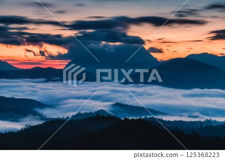 Sunrise over Doi Luang Chiang Dao mountain over sea of fog showcasing tranquil atmosphere from Den TV viewpoint 125368223