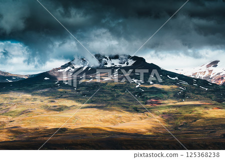 Volcanic mountain under stormy cloud on remote wilderness at Thorsmork, Icelandic Highlands Volcanic mountain under stormy cloud on remote wilderness at Thorsmork, Icelandic Highlands 125368238