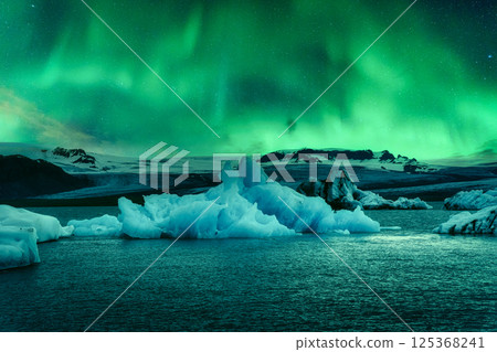 Aurora borealis, Northern lights glowing over abstract iceberg in Jokulsarlon glacier lagoon Aurora borealis, Northern lights glowing over abstract iceberg in Jokulsarlon glacier lagoon 125368241