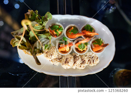 Gourmet seafood spicy shrimp, crispy rice, vegetable serving on table 125368260