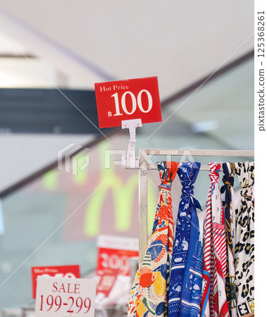 Colorful scarves with promotion price tag at retail store 125368261