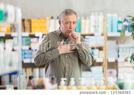 Senior man visits pharmacy and suffers from cough 125368365