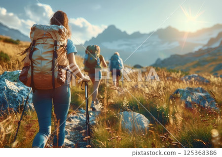 A group friends hiking with large backpacks to along mountain path through. Friends hike through the stunning landscape, their large backpacks ready for the adventure they seek. 125368386
