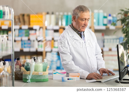 Pharmacist processing supply orders through pharmacy system 125368387