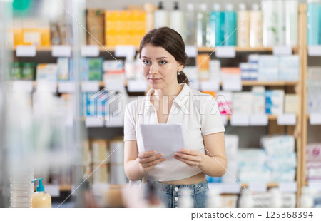 woman holds a medical prescription in her hands woman holds a medical prescription in her hands 125368394