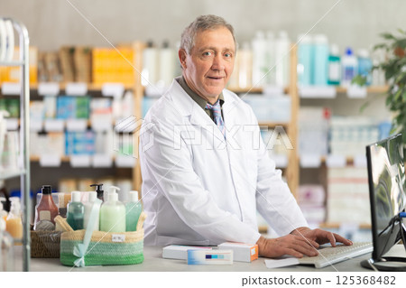 Pharmacist processing supply orders through pharmacy system Pharmacist processing supply orders through pharmacy system 125368482