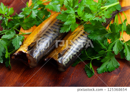 Tasty hot smoked mackerel with greens on wooden surface Tasty hot smoked mackerel with greens on wooden surface 125368654