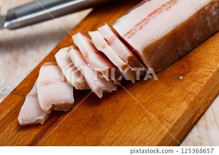Appetizing salted pork belly on a cutting board 125368657