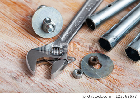 Adjustable wrench on wooden background Adjustable wrench on wooden background 125368658