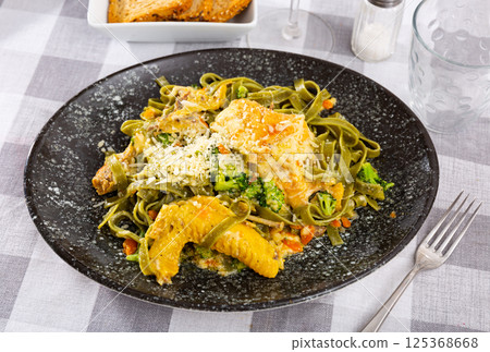 Traditional Italian pasta with meat additive - chicken in cream sauce and broccoli. Traditional Italian pasta with meat additive - chicken in cream sauce and broccoli. 125368668