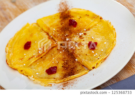 Crepes with cocoa and confiture for breakfast Crepes with cocoa and confiture for breakfast 125368733