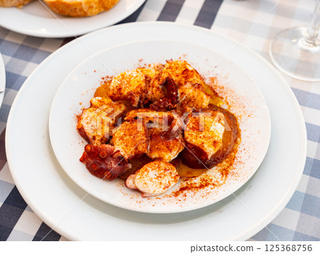 Galician-style octopus served on plate 125368756