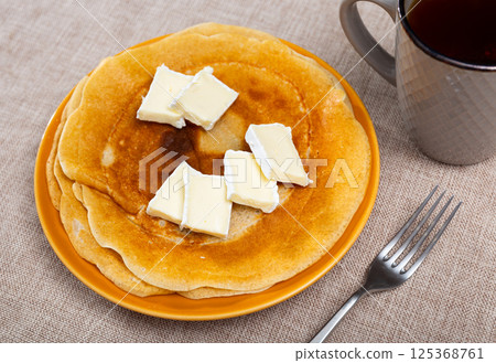 Appetizing delicious pancakes with brie cheese close up Appetizing delicious pancakes with brie cheese close up 125368761
