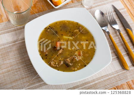 Soup with assorted mushrooms, vegetables and pork 125368828