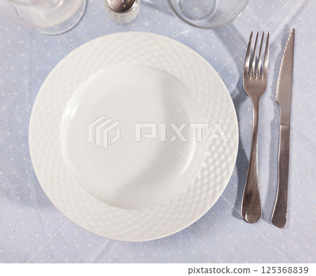 Empty plate with fork and knife Empty plate with fork and knife 125368839