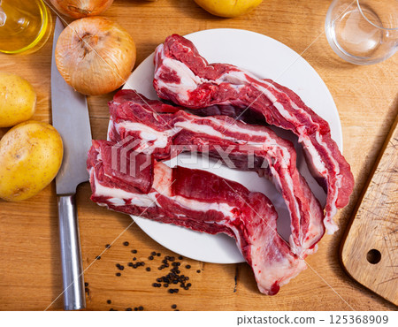 Raw beef brisket served at table Raw beef brisket served at table 125368909