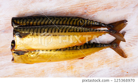 Smoked mackerel fish on wooden table Smoked mackerel fish on wooden table 125368970