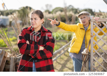 Conflict between female neighbors in country farm Conflict between female neighbors in country farm 125369067