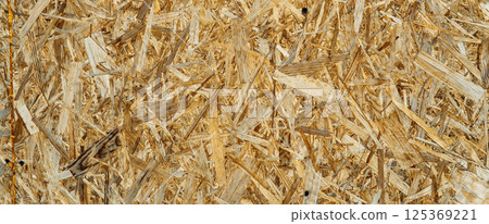 Wooden OSB panel surface with visible texture for wall, floor or ceiling design. Eco-friendly background for decor and renovation projects 125369221