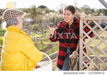 Conflict between female neighbors in country farm Conflict between female neighbors in country farm 125369412