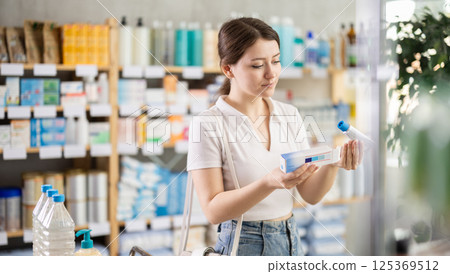 Female customer choosing therapeutic ointment in pharmacy Female customer choosing therapeutic ointment in pharmacy 125369512