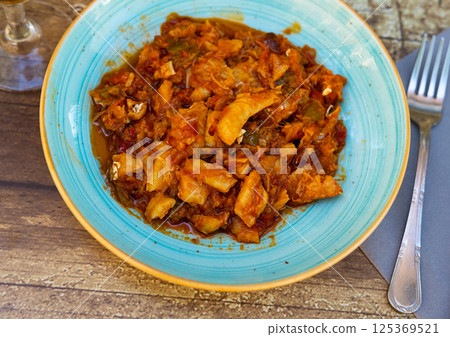 Cod stew with vegetables peppers, tomatoes, garlic and onions close-up in bowl on the table Cod stew with vegetables peppers, tomatoes, garlic and onions close-up in bowl on the table 125369521