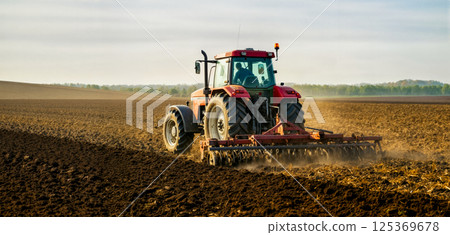farmer on tractor plowing field preparing for planting spring crops, copy space for agriculture and farming concept, care for ecology and traditional methods of land cultivation 125369678