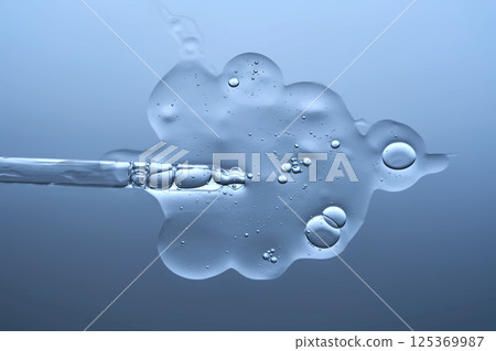 The texture of a serum with microneedles and a cosmetic pipette on a blue background. The texture of a serum with microneedles and a cosmetic pipette on a blue background. 125369987