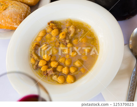 Chickpea stewed with iberian bacon with red wine Chickpea stewed with iberian bacon with red wine 125370023