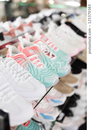 Shelves with different sport shoes in shoes shop Shelves with different sport shoes in shoes shop 125370365