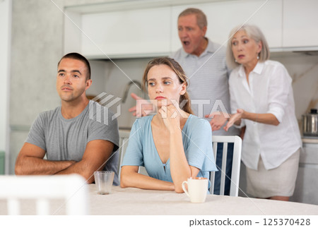 Old couple quarrel with young couple Old couple quarrel with young couple 125370428