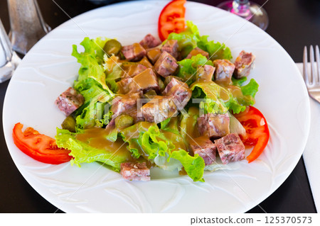 French salad with headcheese, pickles, greens, tomatoes 125370573