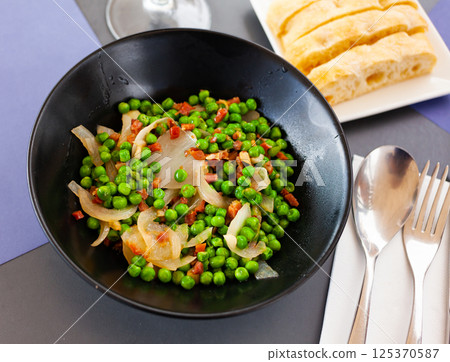 Appetizing dish of peas with ham 125370587
