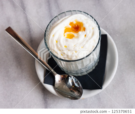 Yogurt foam with honey - sweet delicious dessert Yogurt foam with honey - sweet delicious dessert 125370651