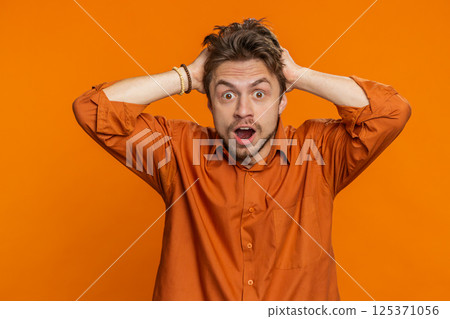 Excited amazed man surprise looking at camera with big eyes, shocked by sudden victory wow emotion 125371056