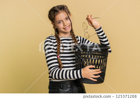 Child girl taking off throwing out glasses into bin, medical vision laser treatment therapy surgery Child girl taking off throwing out glasses into bin, medical vision laser treatment therapy surgery 125371208