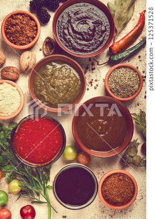 assortment of Georgian sauces and spices, top view, set of spices and tkemali, Georgian, food background, 125371528