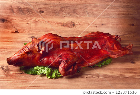 Baked, fried piglet, on a wooden table, no people, Baked, fried piglet, on a wooden table, no people, 125371536