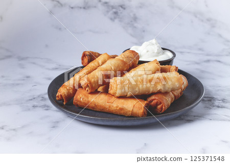 fried spring rolls with cheese, on a plate, with cream sauce, no people, fried spring rolls with cheese, on a plate, with cream sauce, no people, 125371548