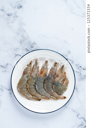 Fresh raw white-footed shrimp, tiger prawns vannamei, on a white plate, Fresh raw white-footed shrimp, tiger prawns vannamei, on a white plate, 125371554