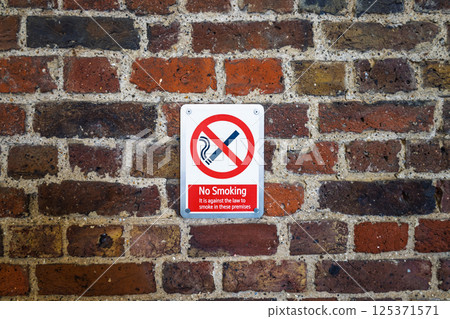 No Smoking Sign on Rustic Brick Wall Prohibiting Smoking in Public Area No Smoking Sign on Rustic Brick Wall Prohibiting Smoking in Public Area 125371571