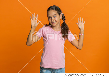 Young cute school girl kid smiling friendly gesturing hello or goodbye, welcoming, waving hands Young cute school girl kid smiling friendly gesturing hello or goodbye, welcoming, waving hands 125372178