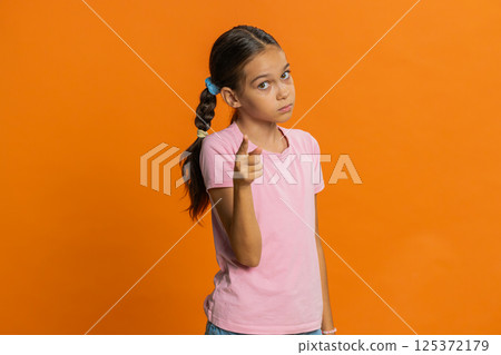 Child girl kid shakes finger and saying no, be careful, avoid danger mistake, disapproval sign 125372179
