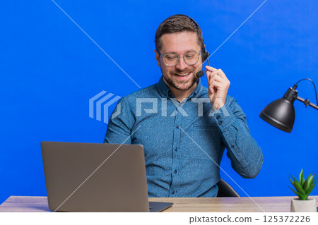 Man freelance worker call center or support service operator helpline having talk with client Man freelance worker call center or support service operator helpline having talk with client 125372226
