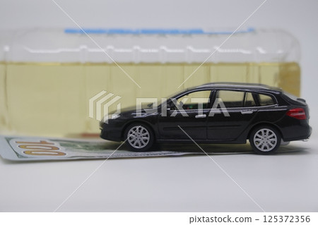 A bottle of vegetable oil and a typewriter lie on a banknote. Biodiesel, biofuel, vegetable oil, 125372356