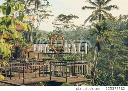 Empty cafe terrace with "Love Bali" sign and view of rice terraces Empty cafe terrace with "Love Bali" sign and view of rice terraces 125372582