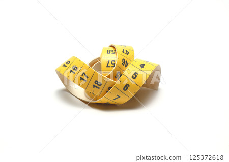 Yellow isolated metric measuring tape isolated on white background. Centimeter, close-up Yellow isolated metric measuring tape isolated on white background. Centimeter, close-up 125372618
