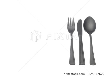 Fork, spoon and knife, isolated on black background. Home kitchen tools and accessories for cooking. Fork, spoon and knife, isolated on black background. Home kitchen tools and accessories for cooking. 125372622