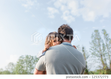 low angle view of small child being carried by a father 125372773